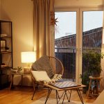 View of a warm light cozy living room in winter with a snowstorm outside